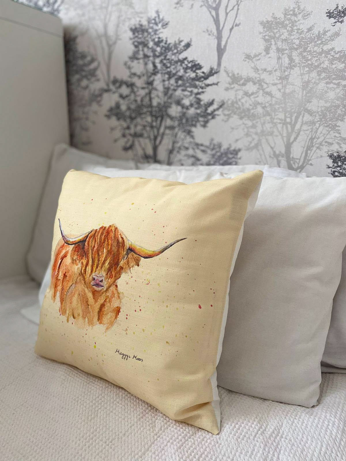 morag highland cow cushion with golden background. Highland cow gifts and homeware range